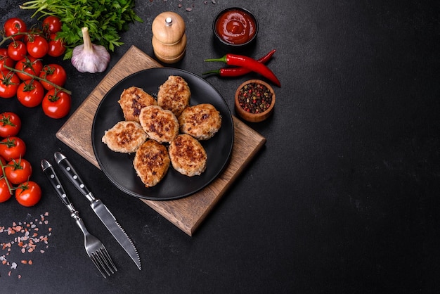 Delicious fresh fried minced meat patties on a dark concrete background