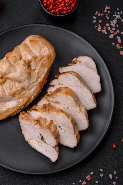 Delicious fresh grilled chicken fillet with salt spices and herbs on a ceramic plate