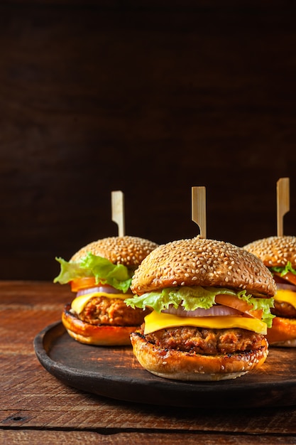 Delicious fresh homemade burger on wooden plate