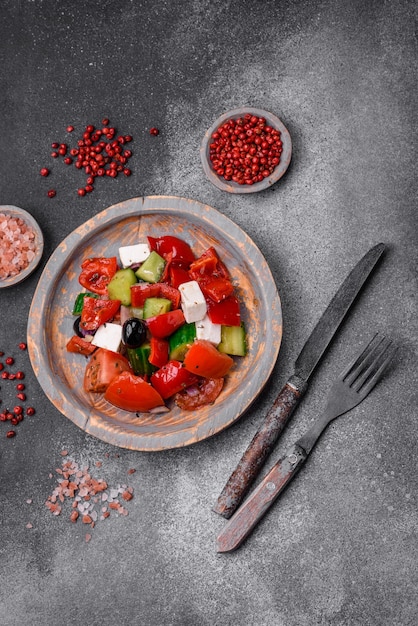 Delicious fresh juicy greek salad with feta cheese olives peppers and tomatoes