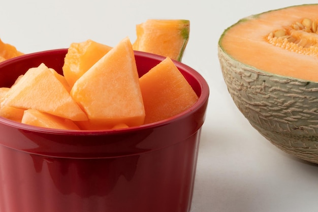 Delicious fresh melon in red bowl Selective focus