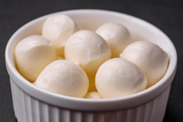 Delicious fresh mozzarella cheese in the form of small balls with salt and spices