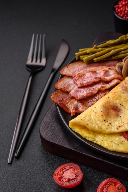 Delicious fresh omelet with cherry tomatoes bacon asparagus and spices