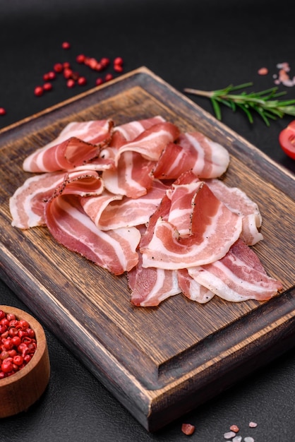 Delicious fresh pancetta with salt and spices cut into thin slices