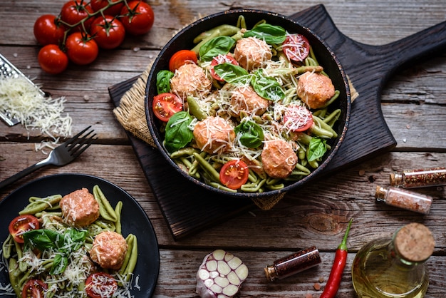 Delicious fresh pasta with meatballs and tomatoes