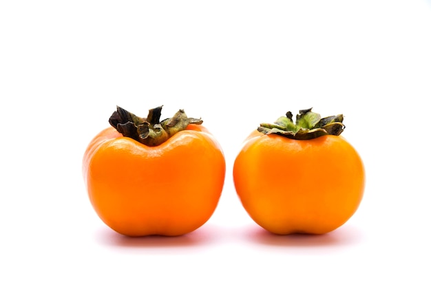 Delicious fresh persimmon fruit isolated on white background.