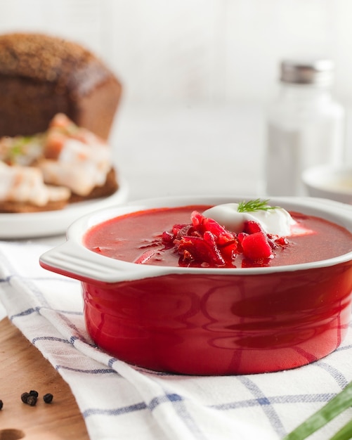 Delicious fresh red borscht dark bread with lard and salt n kitchen table