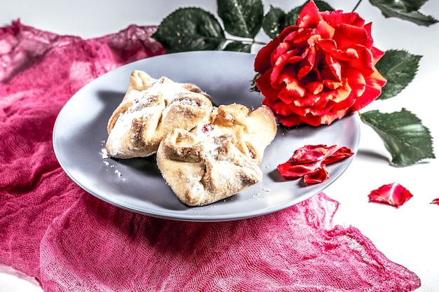 Delicious fresh Romantic breakfast with cookies and a rose on a pink cloth, Sweet, dessert.