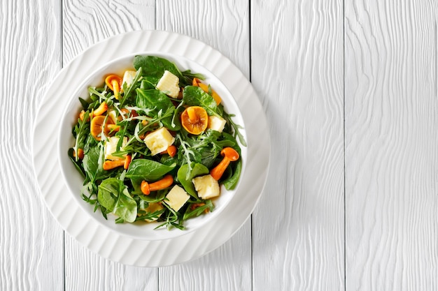 Delicious fresh salad of arugula, spinach, honey mushrooms and cubed cheddar cheese