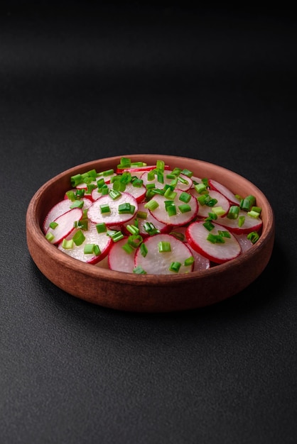 Delicious fresh salad of sliced radishes with green onions salt and olive oil