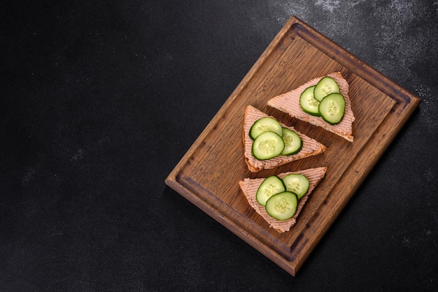 Delicious fresh sandwich with chicken liver pate with crispy toast butter and cucumber