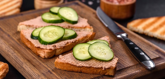 Delicious fresh sandwich with chicken liver pate with crispy toast butter and cucumber