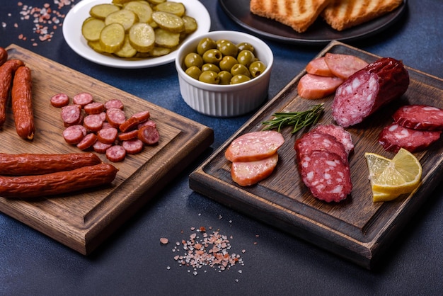 Delicious fresh smoked sausages cut with slices on a wooden cutting board