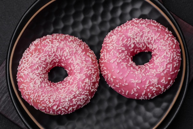 Delicious fresh sweet donuts in pink glaze with strawberry filling