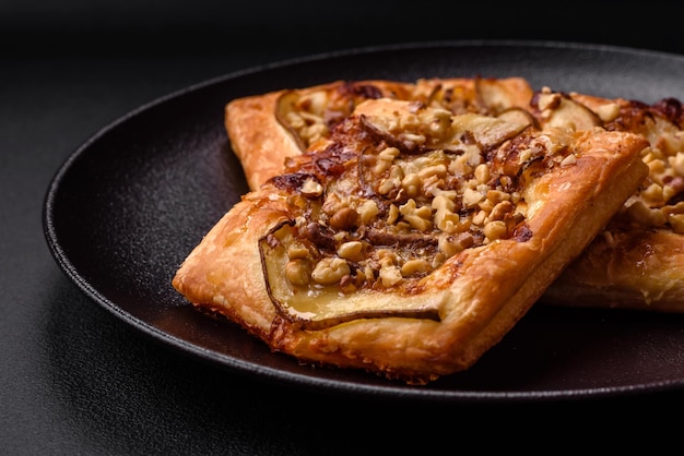 Delicious fresh sweet pie or pizza with pear brie cheese honey and nuts