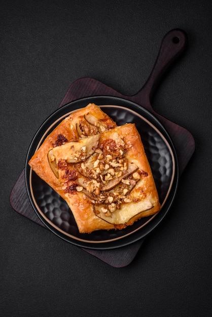 Delicious fresh sweet pie or pizza with pear brie cheese honey and nuts