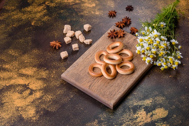 Delicious fresh vanilla corn dough bagels on a yellow concrete background