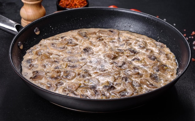 Delicious fresh young champignons sliced into slices in creamy sauce