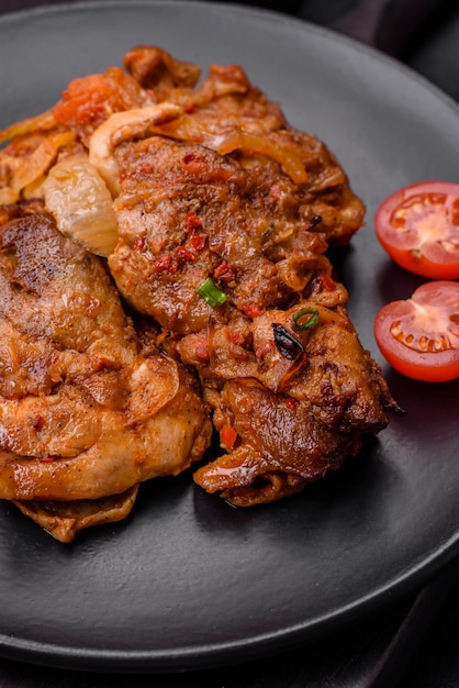 Delicious fried chicken in sauce with onions salt spices and herbs