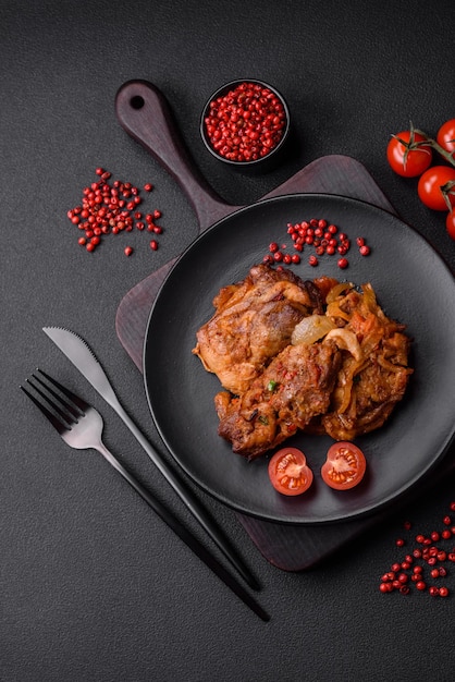 Delicious fried chicken in sauce with onions salt spices and herbs