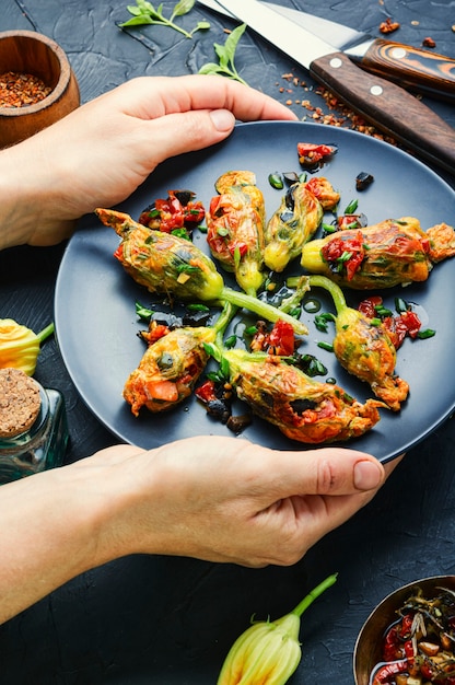 Delicious fried zucchini flowers stuffed with sun-dried tomatoes.Summer food.