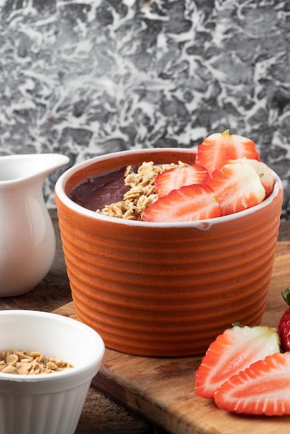 Delicious frozen acai with granola and strawberry Selective focus