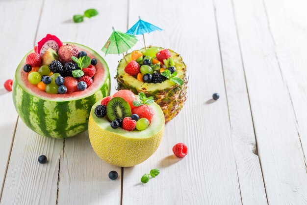 Delicious fruits salad in melon and watermelon with berry fruits