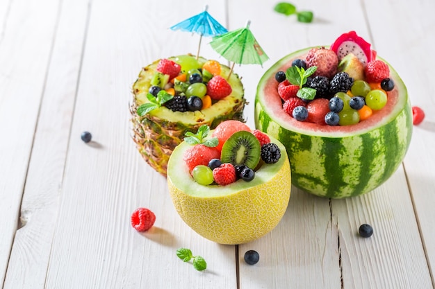 Delicious fruits salad in watermelon with berry fruits