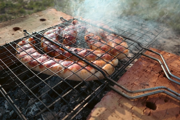 Delicious german sausages on the barbecue grill barbecue grill at bbq party in summer garden