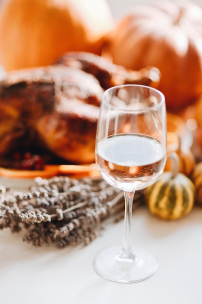 Delicious golden roasted Thanksgiving turkey on dinner table with pumpkins