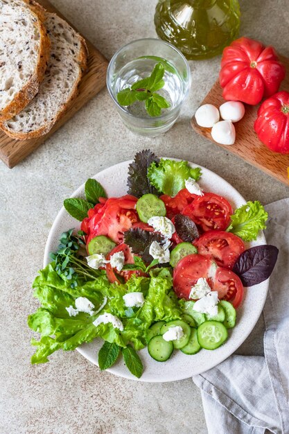 Delicious green salad with salad leaves mix tomatoes cucumber mozzarella and micro green