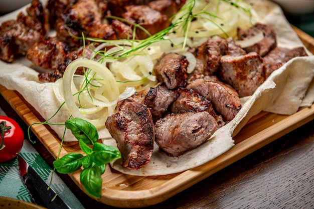 Delicious grilled pork shashlik on wooden table