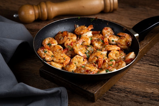 Delicious grilled prawns on wooden background