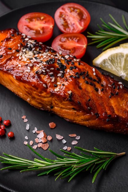 Delicious grilled red salmon fish with sauce sesame seeds spices and herbs