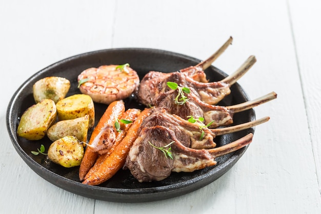 Delicious grilled ribs of lamb on white background