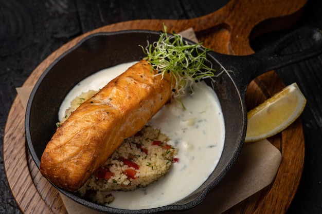 delicious grilled salmon in the restaurant. On a dark background