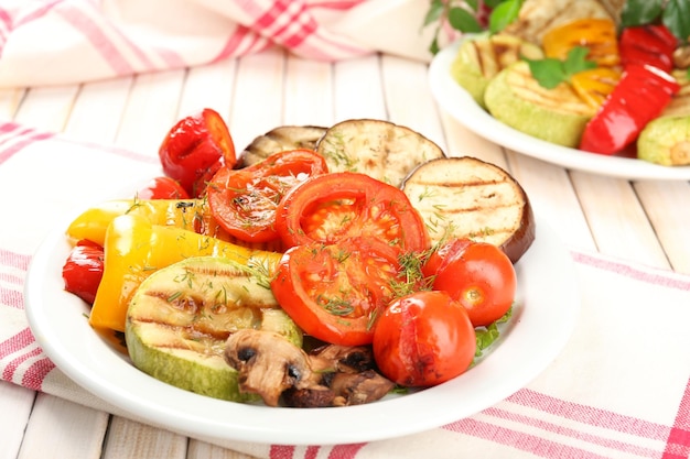 Delicious grilled vegetables on plate on table closeup