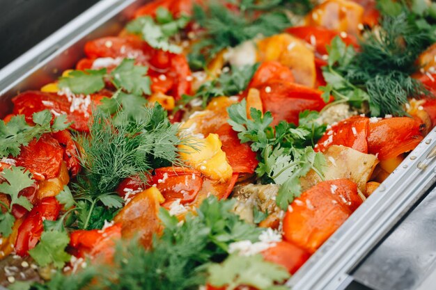 Delicious grilled vegetables with parsley closeup on street catering