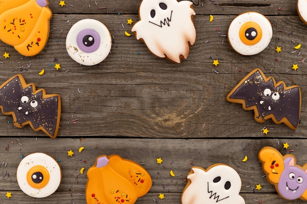 Delicious halloween homemade cookies of various shapes on old wooden table