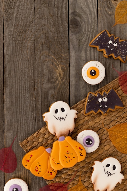 Delicious halloween homemade cookies of various shapes on old wooden table