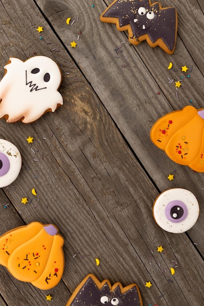 Delicious halloween homemade cookies of various shapes on old wooden table