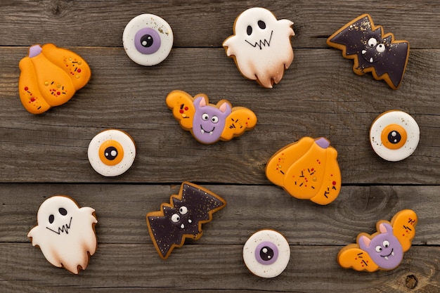 Delicious halloween homemade cookies of various shapes on old wooden table