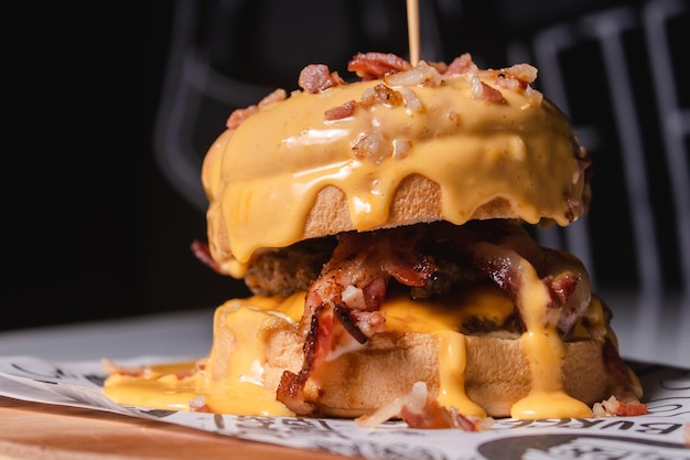 Delicious hamburger topped with melted cheese on a wooden board