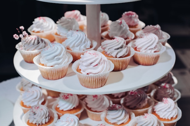 Delicious handmade cupcakes on layered display.