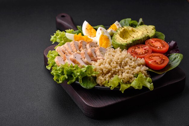 Delicious healthy lunch consisting of chicken avocado quinoa eggs and tomatoes