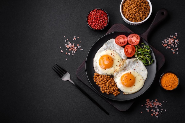 Delicious hearty breakfast consisting of two fried eggs canned lentils and microgreens