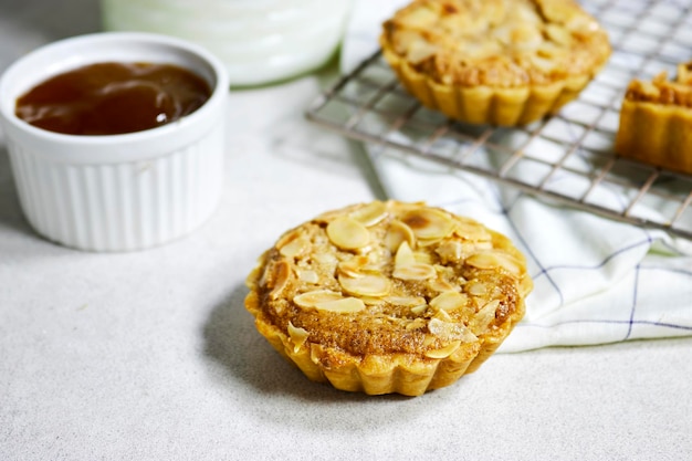 delicious homemade almond pies or tartlet with apricot jam and milk bottle