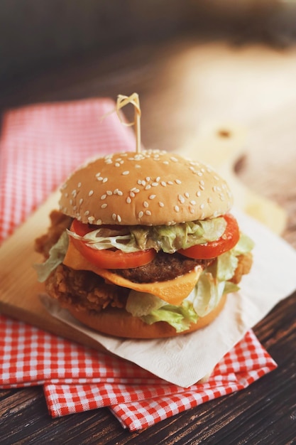 Delicious homemade beef burger on wooden table.