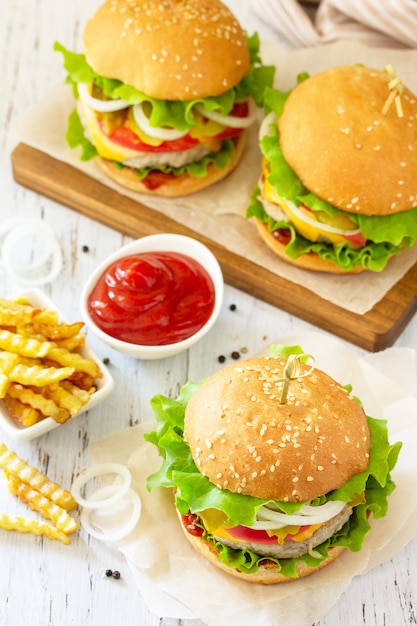 Delicious homemade burgers with cutlet cheese bacon tomatoes and french fries Copy space