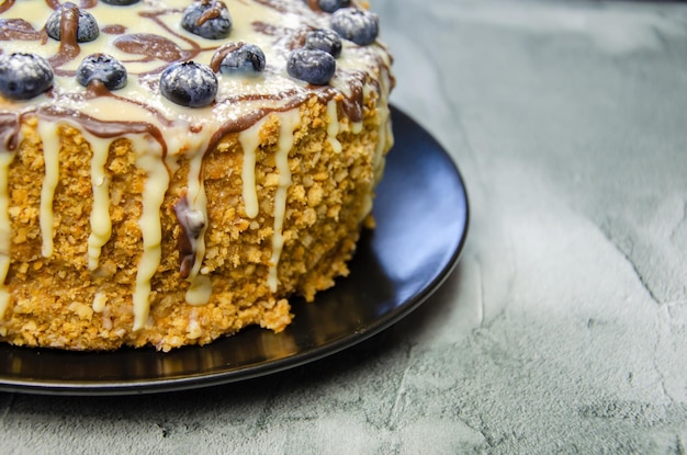 Delicious homemade cake on textured concrete background closeup cake with blueberries and cream